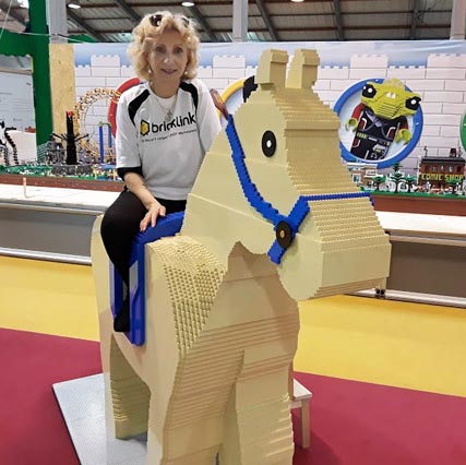 Eliska riding a LEGO horse